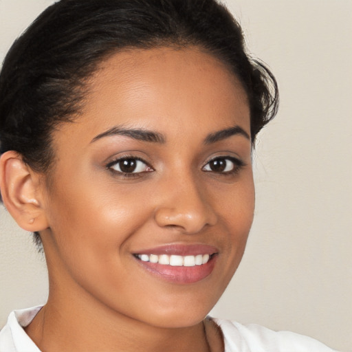 Joyful latino young-adult female with short  brown hair and brown eyes