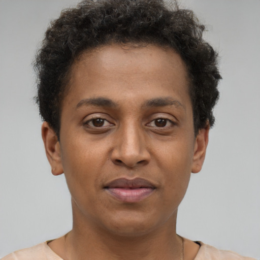 Joyful latino young-adult male with short  brown hair and brown eyes