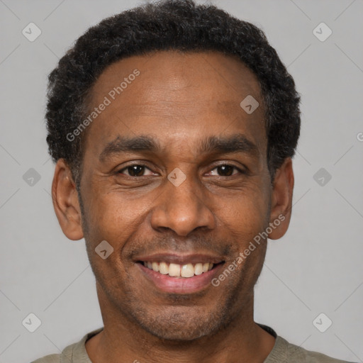 Joyful black adult male with short  black hair and brown eyes