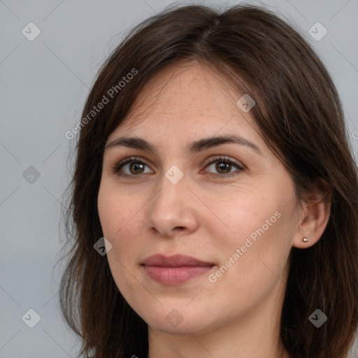 Joyful white adult female with long  brown hair and brown eyes