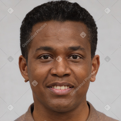 Joyful black young-adult male with short  brown hair and brown eyes