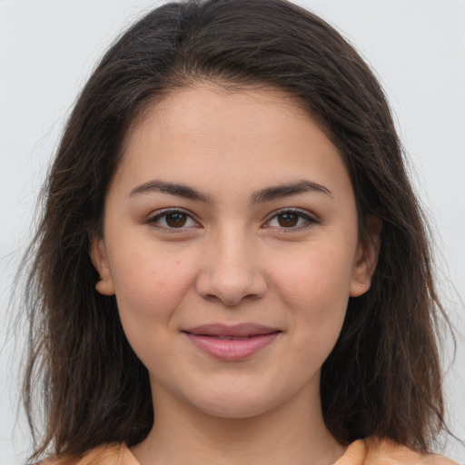 Joyful white young-adult female with long  brown hair and brown eyes