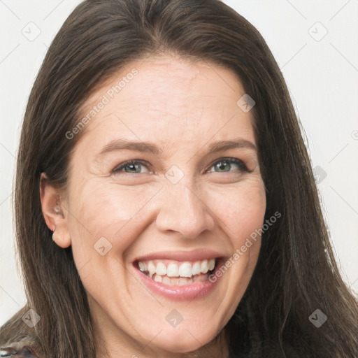 Joyful white adult female with long  brown hair and brown eyes