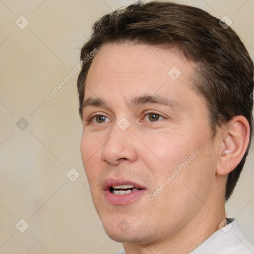 Joyful white adult male with short  brown hair and brown eyes