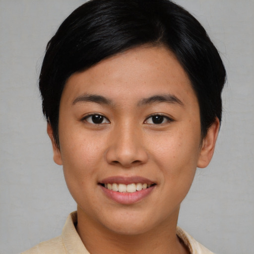 Joyful asian young-adult female with short  black hair and brown eyes