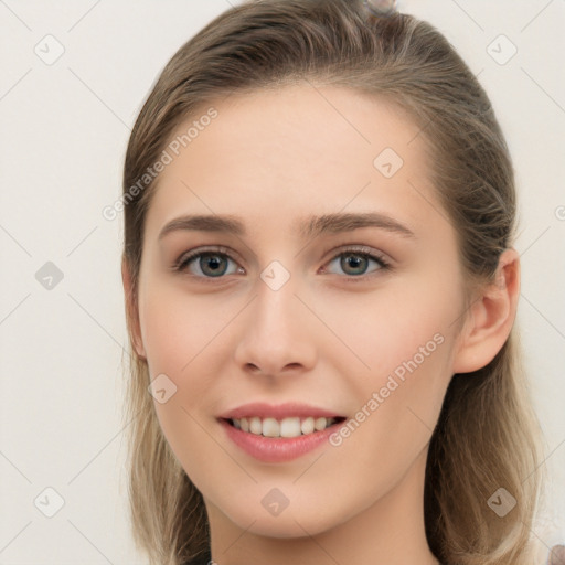 Joyful white young-adult female with long  brown hair and grey eyes