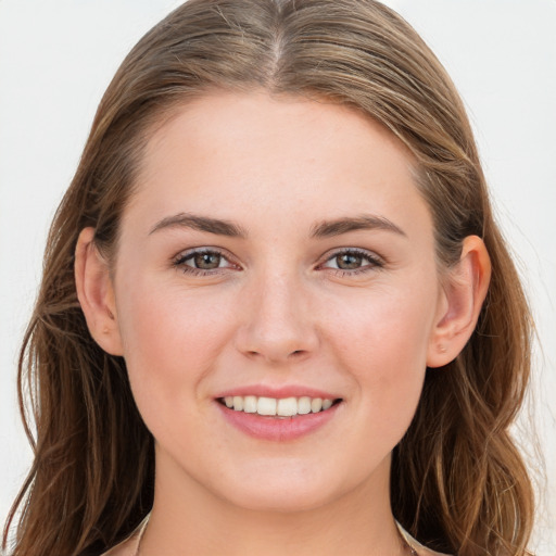 Joyful white young-adult female with long  brown hair and blue eyes