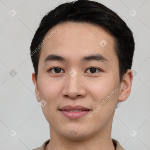 Joyful asian young-adult male with short  black hair and brown eyes