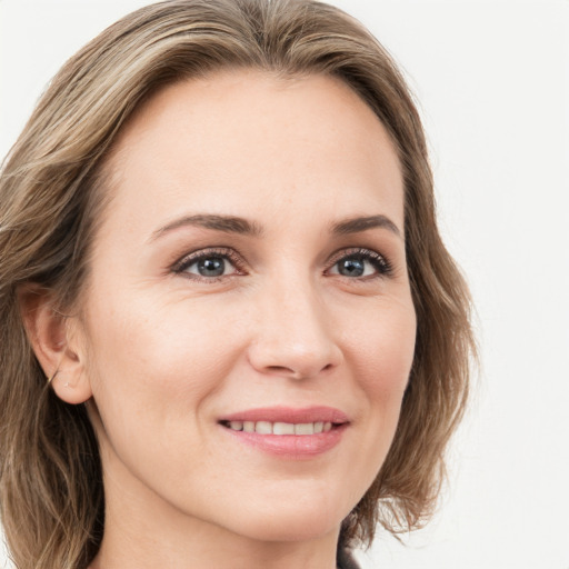 Joyful white young-adult female with medium  brown hair and green eyes