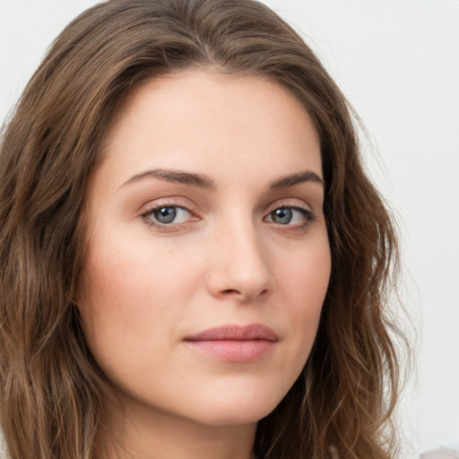 Neutral white young-adult female with long  brown hair and green eyes