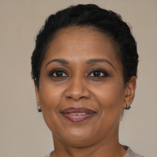 Joyful black adult female with short  brown hair and brown eyes