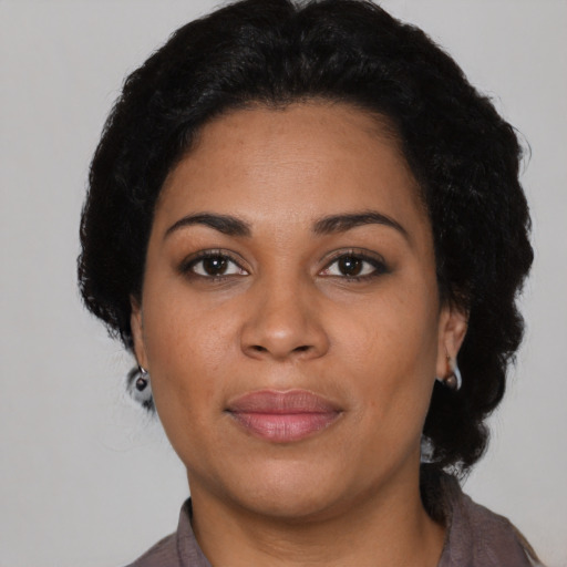 Joyful latino young-adult female with short  black hair and brown eyes