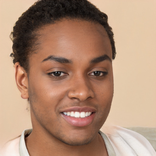 Joyful black young-adult female with short  brown hair and brown eyes