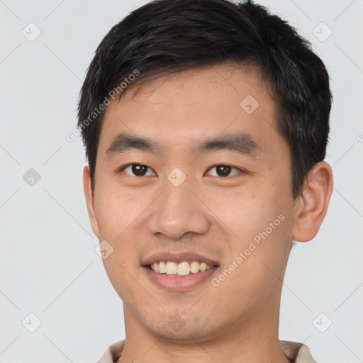 Joyful white young-adult male with short  black hair and brown eyes