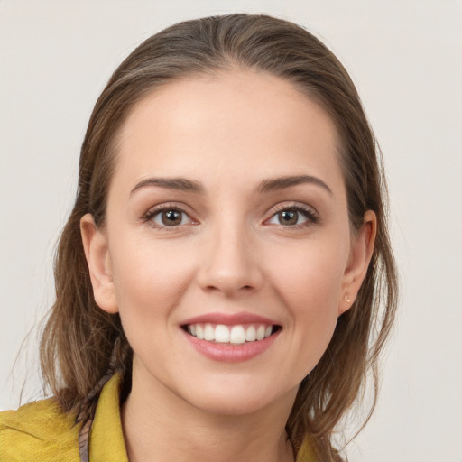 Joyful white young-adult female with medium  brown hair and brown eyes