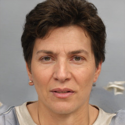 Joyful white adult female with short  brown hair and grey eyes