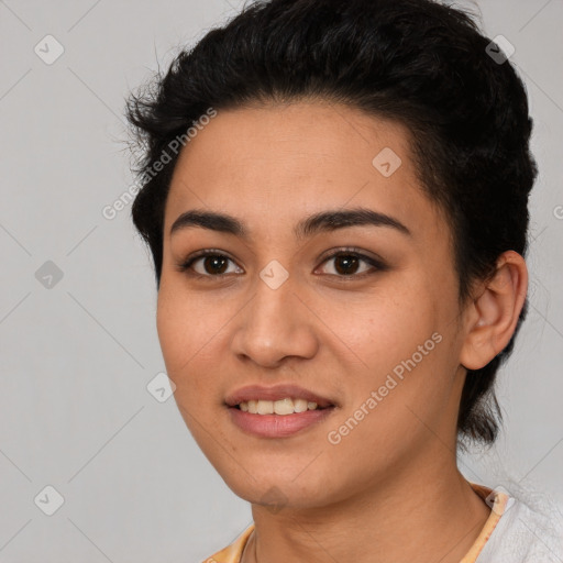 Joyful latino young-adult female with short  black hair and brown eyes