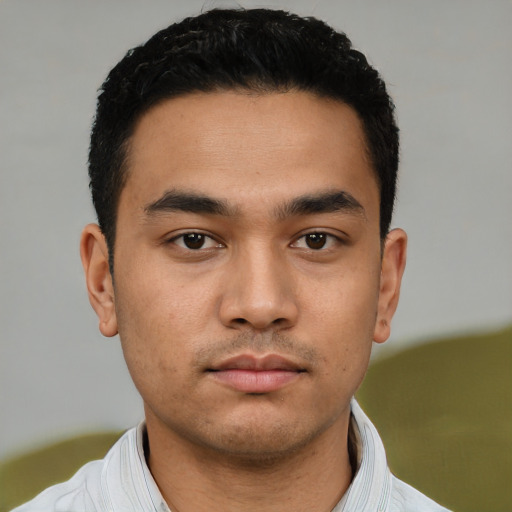 Neutral latino young-adult male with short  black hair and brown eyes
