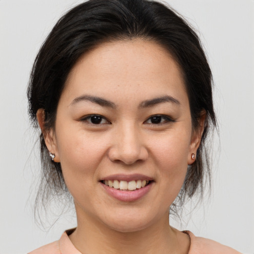 Joyful asian young-adult female with medium  brown hair and brown eyes