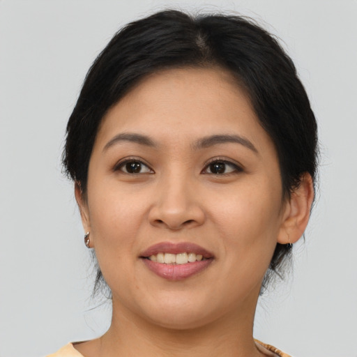 Joyful asian adult female with medium  brown hair and brown eyes