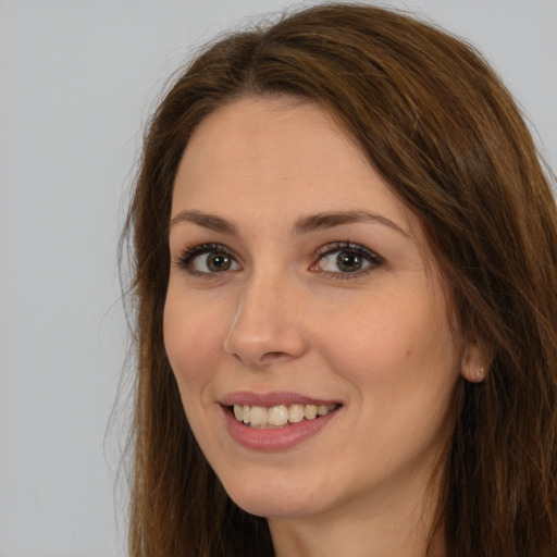 Joyful white young-adult female with long  brown hair and brown eyes