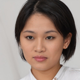 Joyful asian young-adult female with medium  black hair and brown eyes