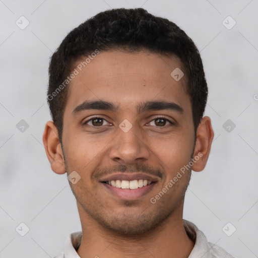 Joyful latino young-adult male with short  brown hair and brown eyes