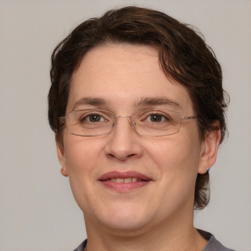 Joyful white adult female with medium  brown hair and grey eyes