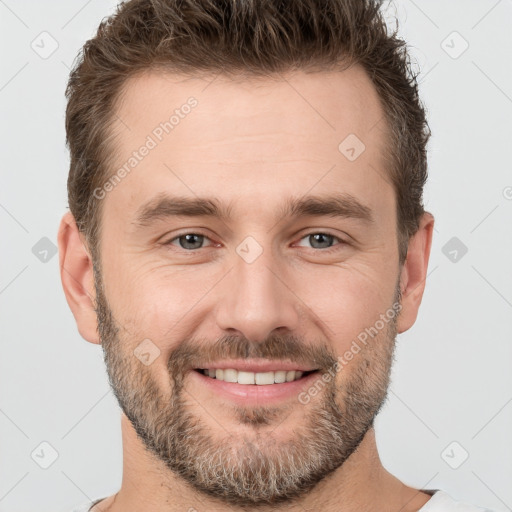 Joyful white adult male with short  brown hair and brown eyes