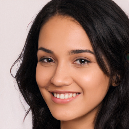 Joyful latino young-adult female with long  black hair and brown eyes