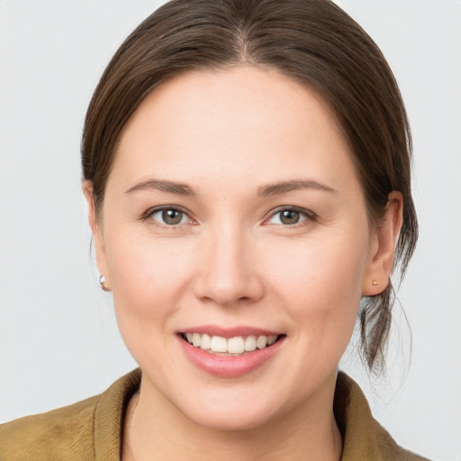 Joyful white young-adult female with medium  brown hair and brown eyes