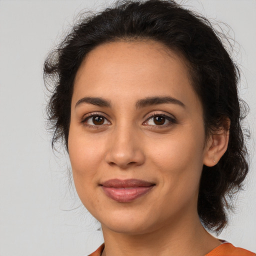 Joyful latino young-adult female with medium  brown hair and brown eyes