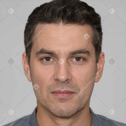 Joyful white adult male with short  brown hair and brown eyes