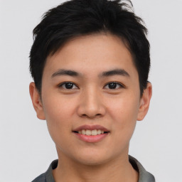 Joyful asian young-adult male with short  black hair and brown eyes