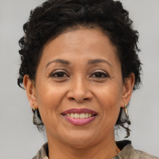 Joyful latino adult female with medium  brown hair and brown eyes