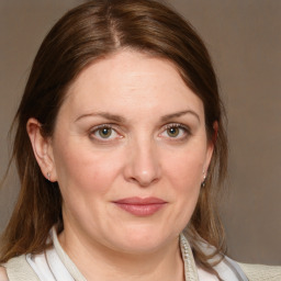 Joyful white adult female with medium  brown hair and blue eyes