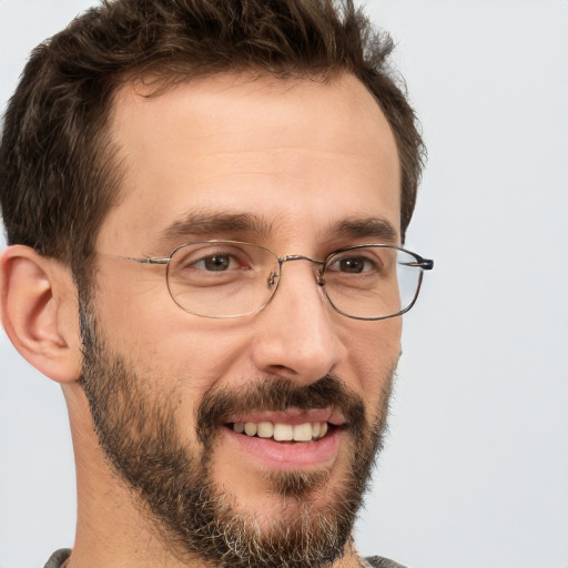 Joyful white adult male with short  brown hair and brown eyes