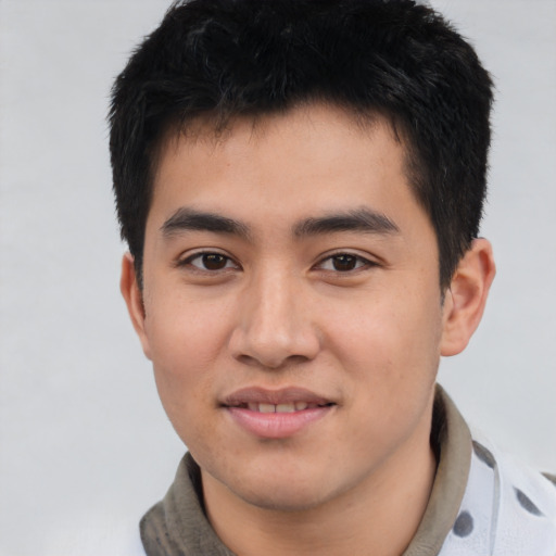 Joyful asian young-adult male with short  black hair and brown eyes