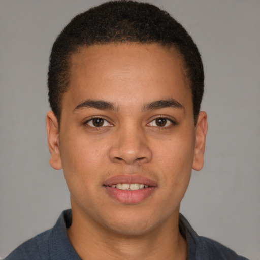 Joyful latino young-adult male with short  brown hair and brown eyes