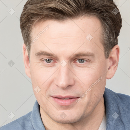 Joyful white adult male with short  brown hair and grey eyes