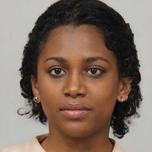 Neutral black young-adult female with medium  brown hair and brown eyes