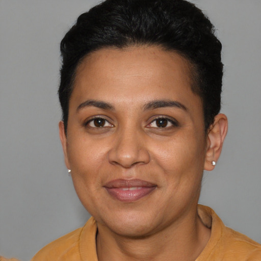 Joyful latino young-adult female with short  brown hair and brown eyes