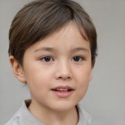 Joyful white child female with short  brown hair and brown eyes