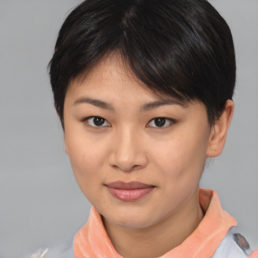 Joyful asian young-adult female with short  brown hair and brown eyes