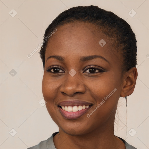 Joyful black young-adult female with short  black hair and brown eyes