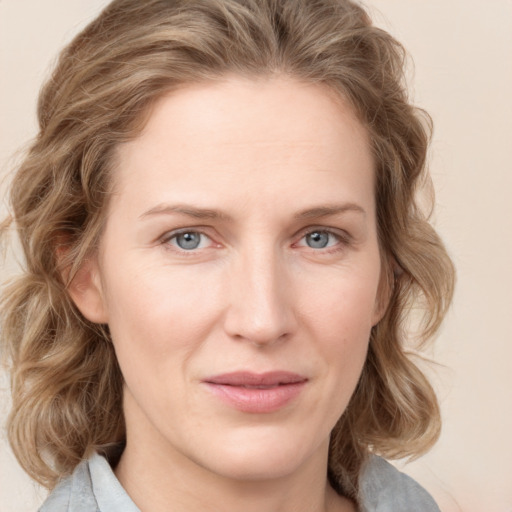 Joyful white young-adult female with medium  brown hair and blue eyes