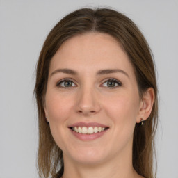 Joyful white young-adult female with long  brown hair and green eyes