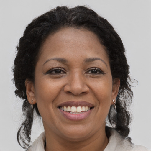 Joyful black adult female with medium  brown hair and brown eyes