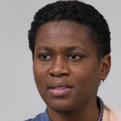 Joyful black young-adult female with short  black hair and brown eyes