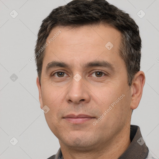 Joyful white adult male with short  brown hair and brown eyes